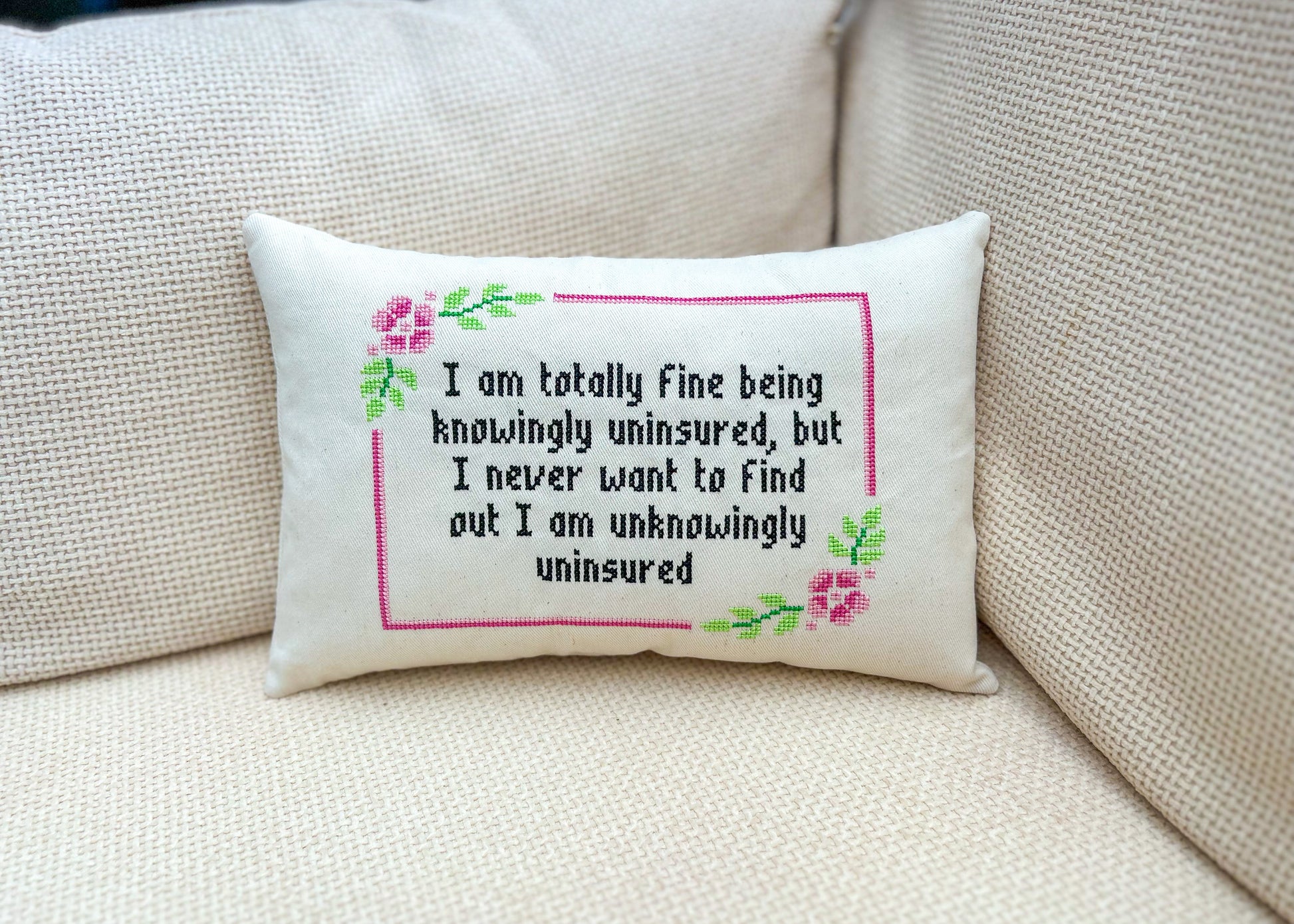 Decorative pillow with a humorous quote on a beige couch