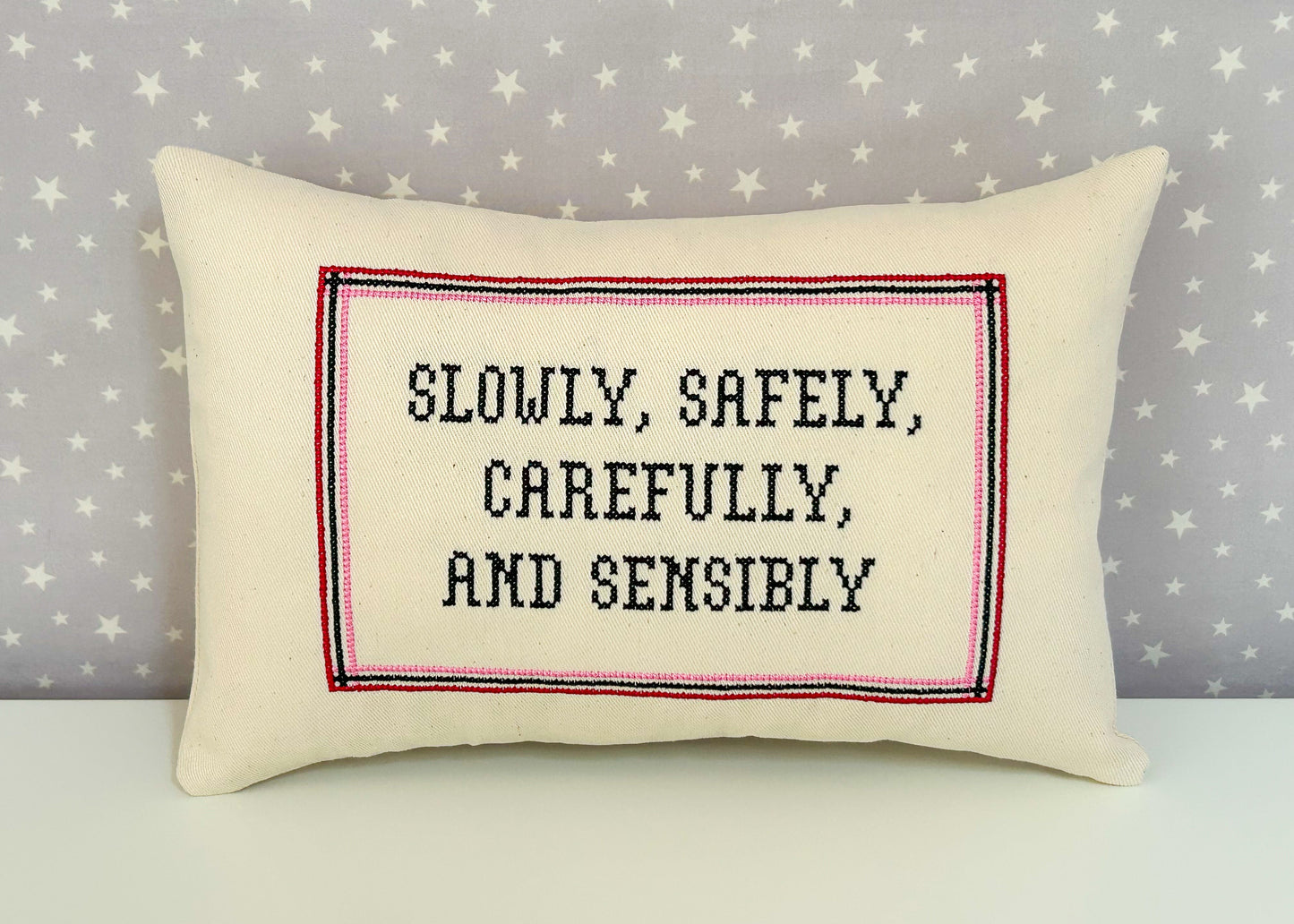 Decorative pillow with text on a star-patterned background