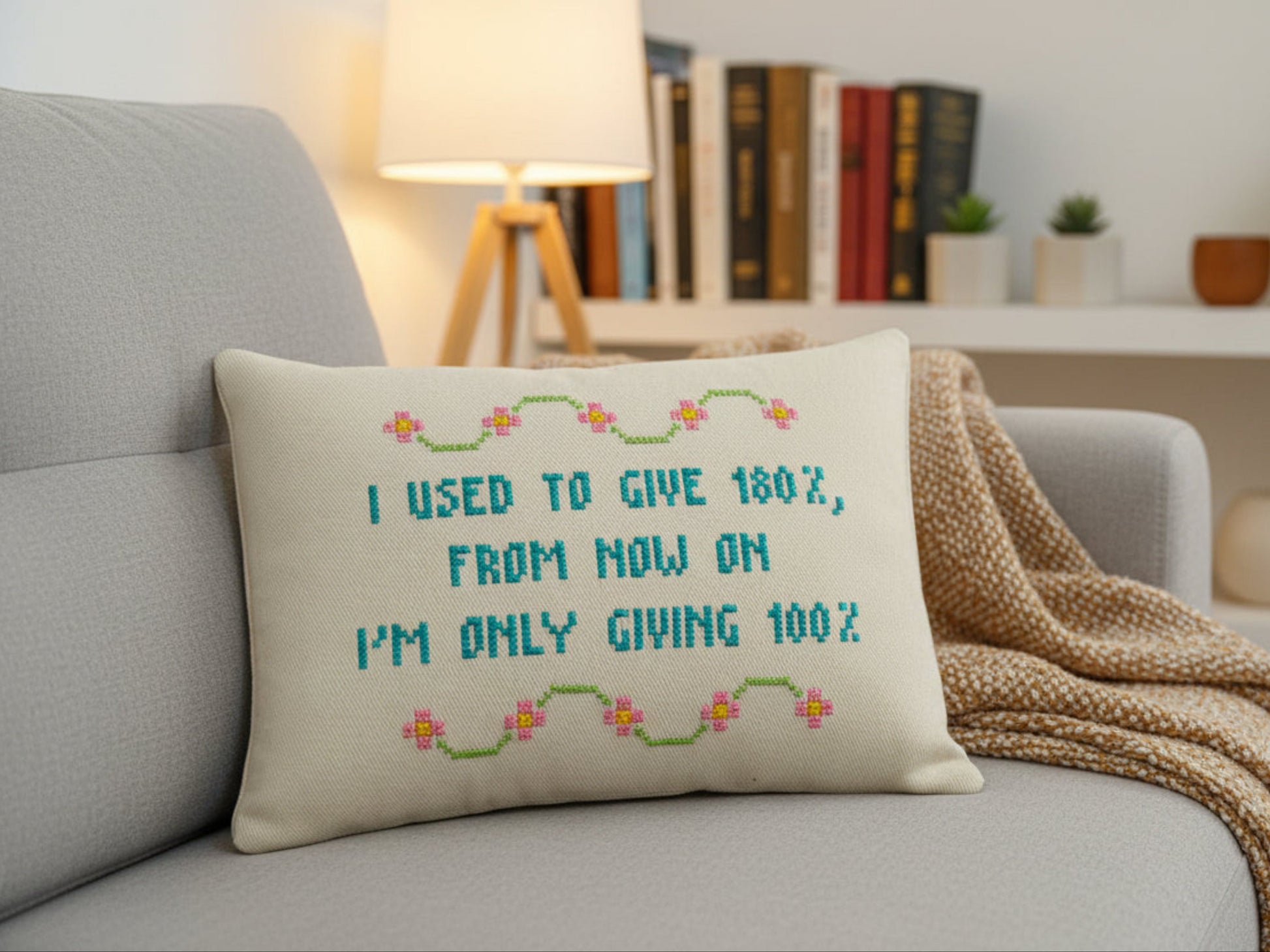 Decorative pillow with text on a couch in a living room setting
