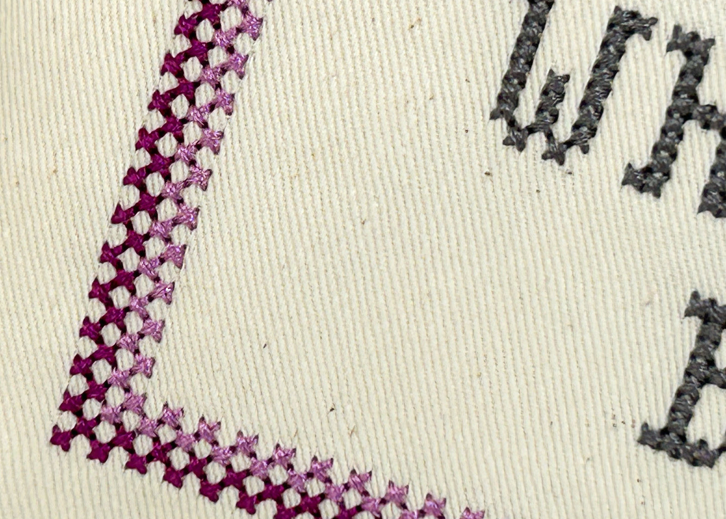 Textured fabric with embroidered corner and text