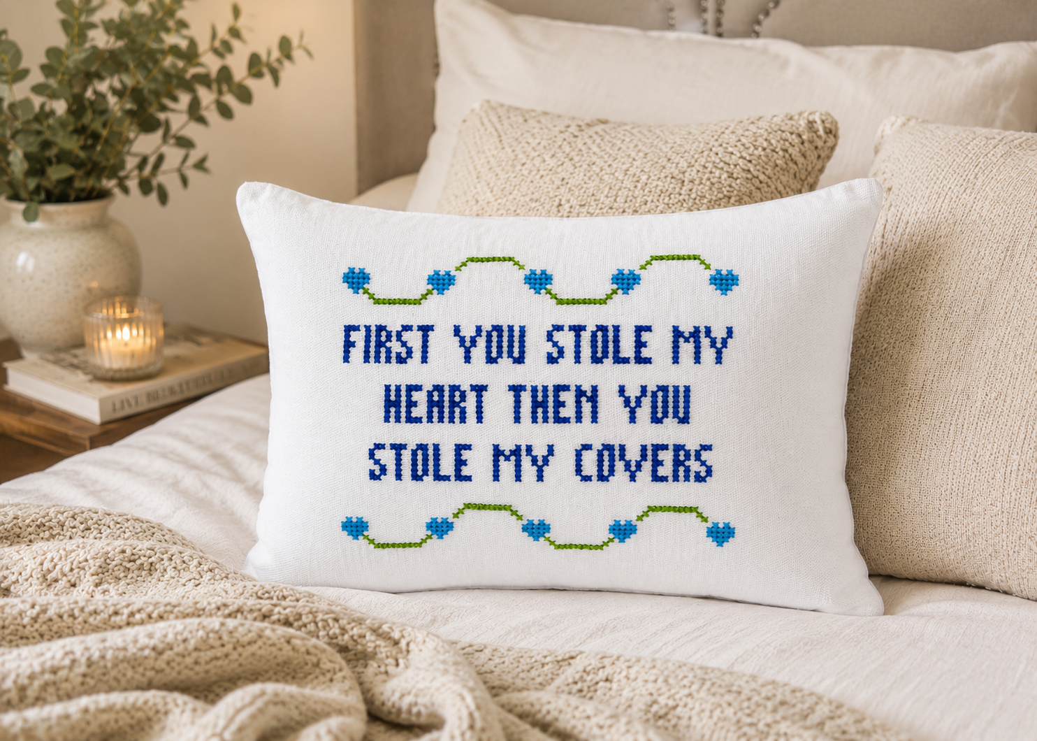 Decorative pillow with embroidered text on a couch