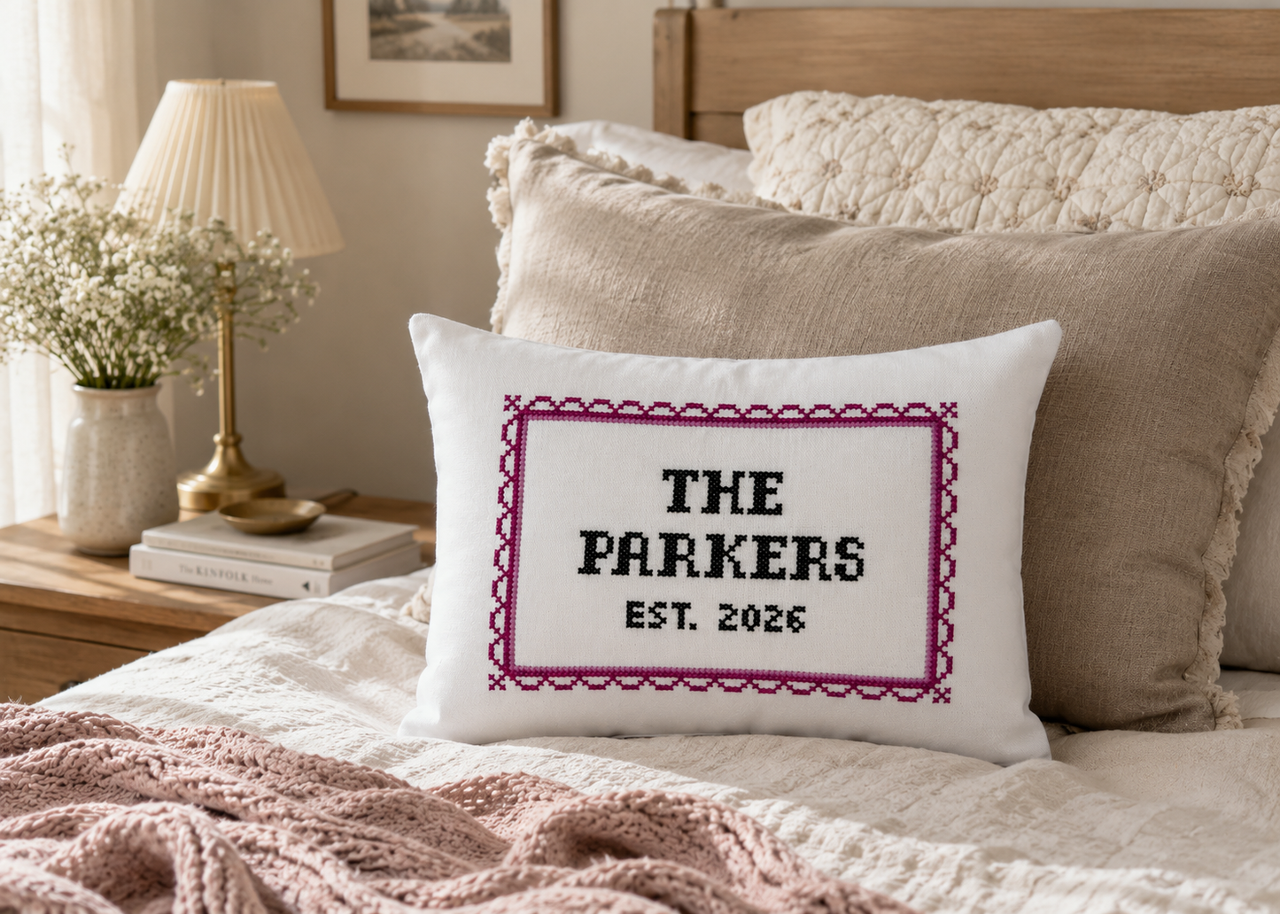Decorative pillow with 'The Parkers Est. 2026' text on a bed in a bedroom setting.