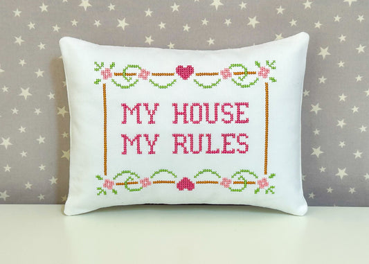 Decorative pillow with cross-stitched text 'My House My Rules' on a star-patterned background