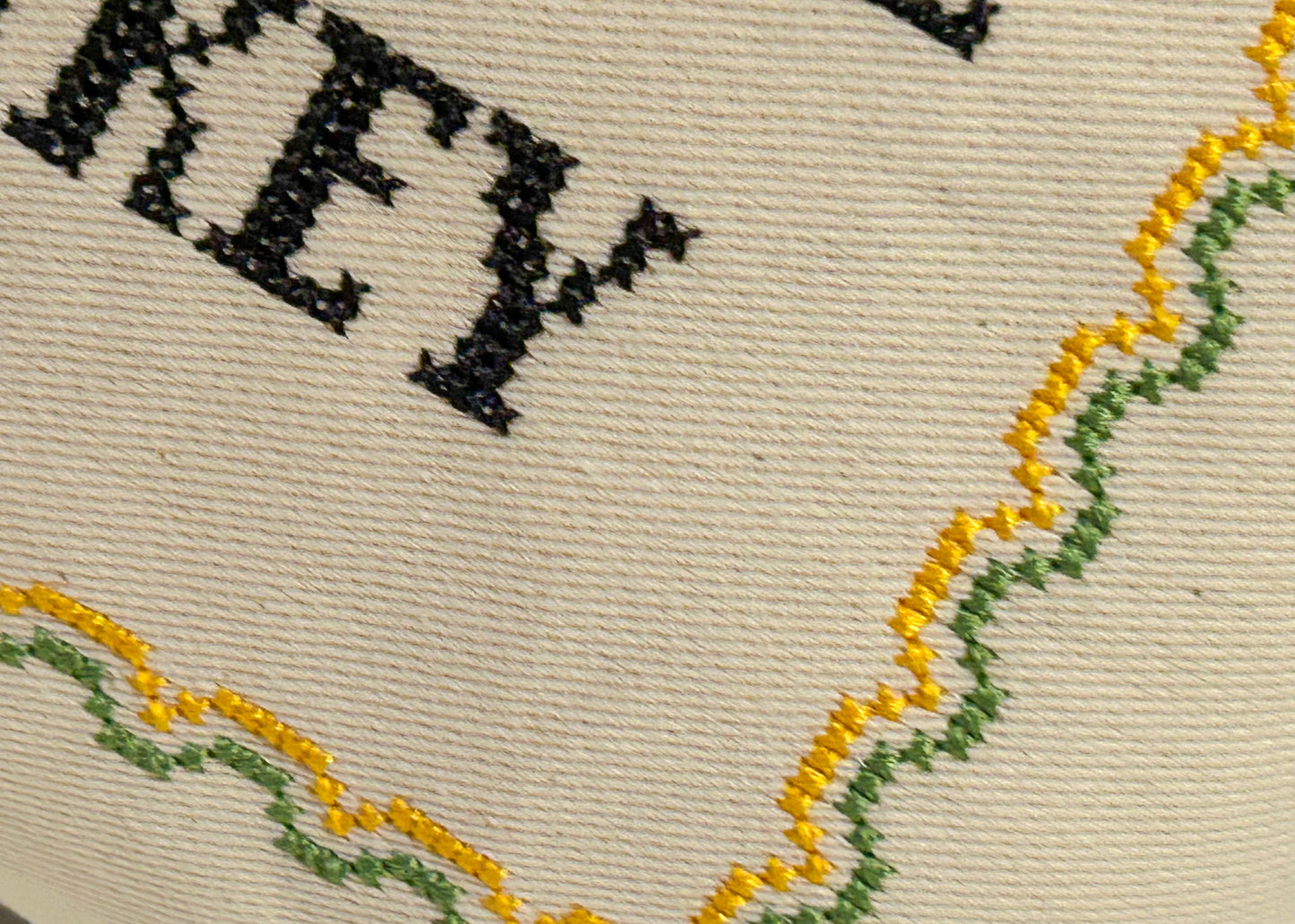 Close up cross stitch on a pillow