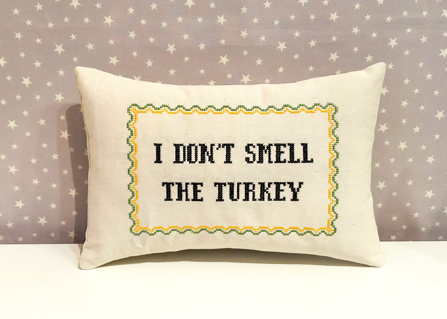 Decorative pillow with text 'I don't smell the turkey' on a star-patterned background