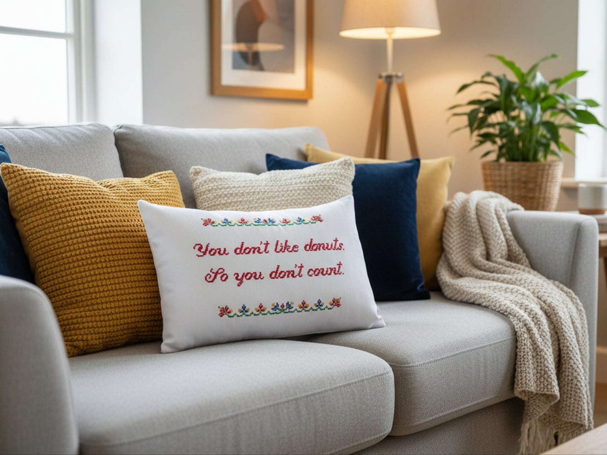 Decorative pillow with text on a couch in a living room setting