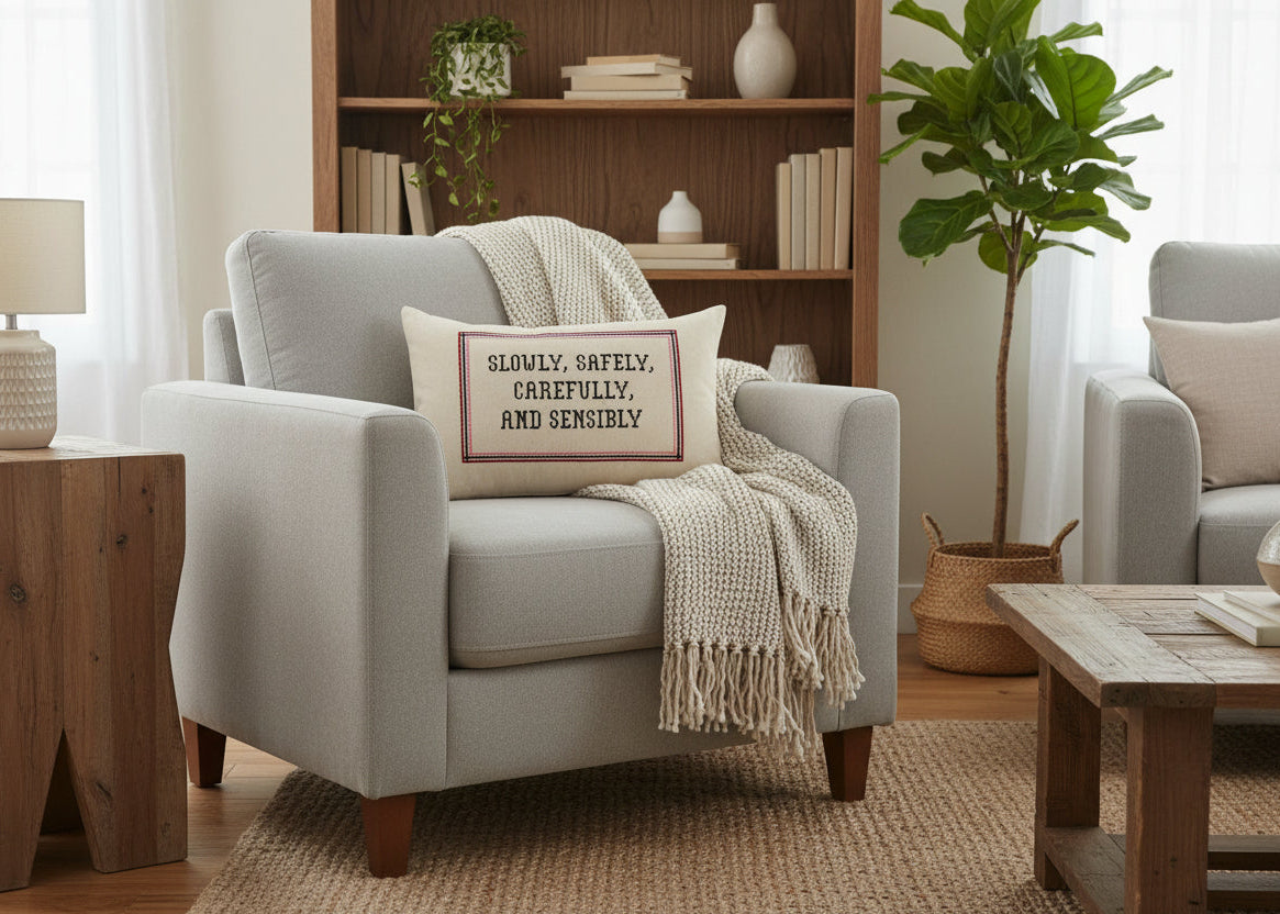 Cozy living room with a gray armchair, wooden coffee table, and bookshelf.