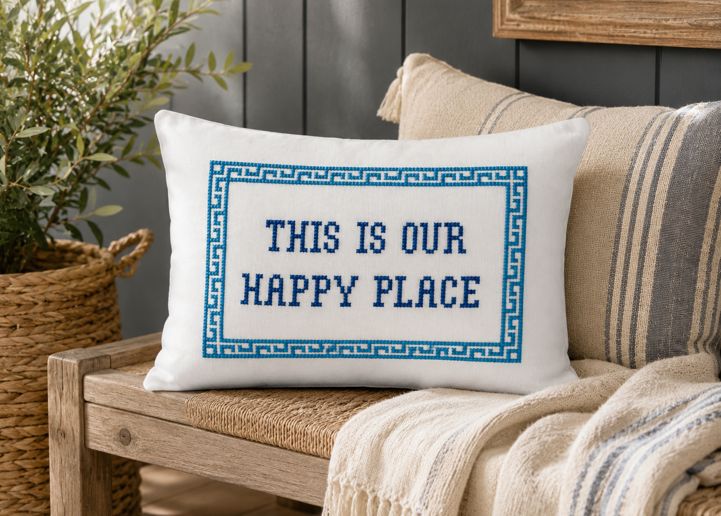 Decorative pillow with 'This is our happy place' text on a couch