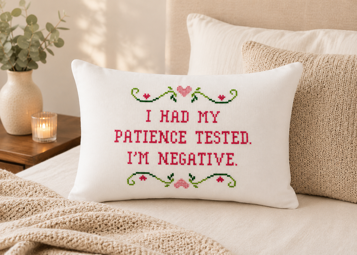 Decorative pillow with embroidered text on a bed