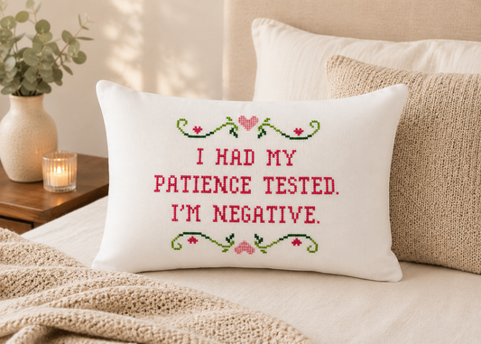 Decorative pillow with embroidered text on a bed