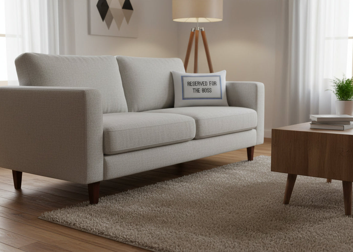 Gray sofa in a living room with a wooden coffee table and decorative items.