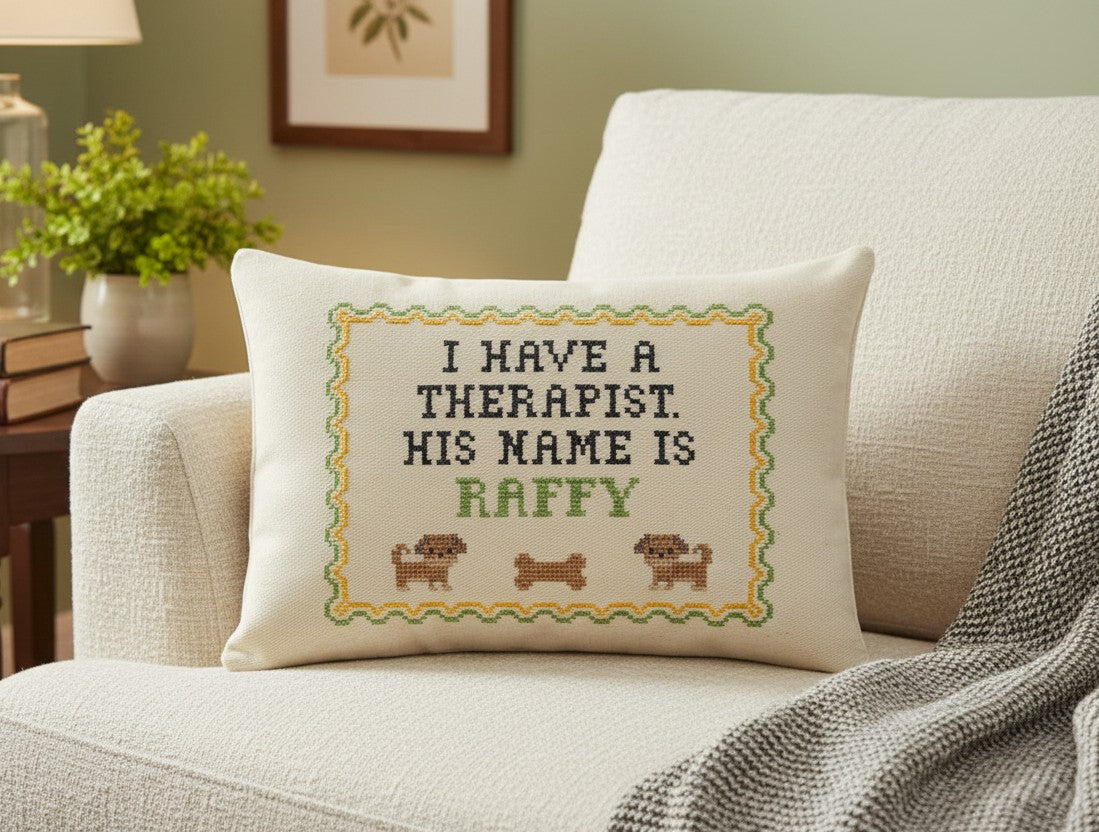 Decorative pillow with text 'I have a therapist. His name is Raffy' on a couch.